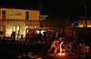 A crowd watches as blacksmiths demonstrate the pouring of molten iron