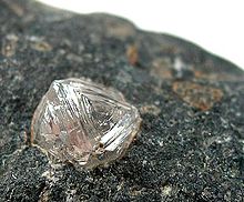 a lump of rock, with a large colorless crystal embedded into it