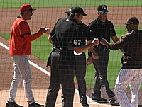 San Diego Padres manager Jayce Tingler and Cincinnati Reds bench coach Freddie Benavides greet umpires with fist bumps prior to a game in 2021.