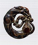 Harness ornament in the shape of a coiled wolf, characteristic of nomadic artifacts of southern Ningxia and southeastern Gansu, 5th-4th century BC.[107][104]