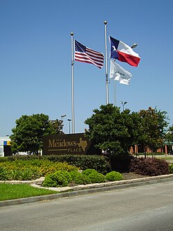 A sign indicating Meadows Place