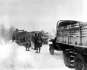 Army vehicles coping with snow during the Battle of the Bulge of World War II.