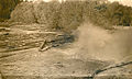 Splash of logs being dumped into a log pond