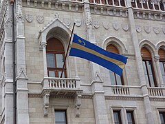 Székely flag on the Houses of Parliament, Budapest, Hungary