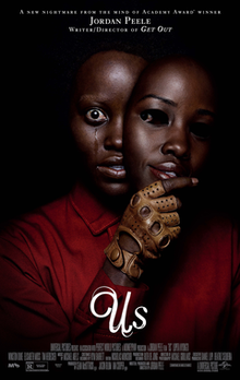 In a black background, Lupita Nyong'o (portraying as her respective role and seen wearing a red jumpsuit) looks out at the viewer while holding a mask of herself. A tear is seen streaming out of her eye.