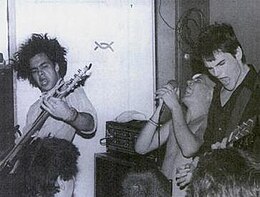 Embrace at Food for Thought in July 1985. From left to right are Chris Bald, Ian MacKaye, and Mike Hampton. The drummer, Ivor Hanson, is out of frame.