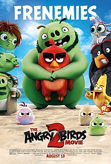 Film poster showing Leonard (a bearded green pig) hugging Red (a red bird) at the beach. On the left are three green pigs, on the right are three birds. Beneath are three angry hatchlings. Beneath the characters is the title of the movie. Above the poster is the text "FRENEMIES". The credits and production details are beneath the poster.