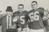 Head coach Carnie Smith with All-Americans Gary Snadon and Harlan Hess and the UPI national championship trophy