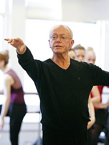 Burmann, standing in a ballet position with an outstretched arm